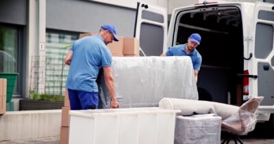 professional movers loading furniture into moving van